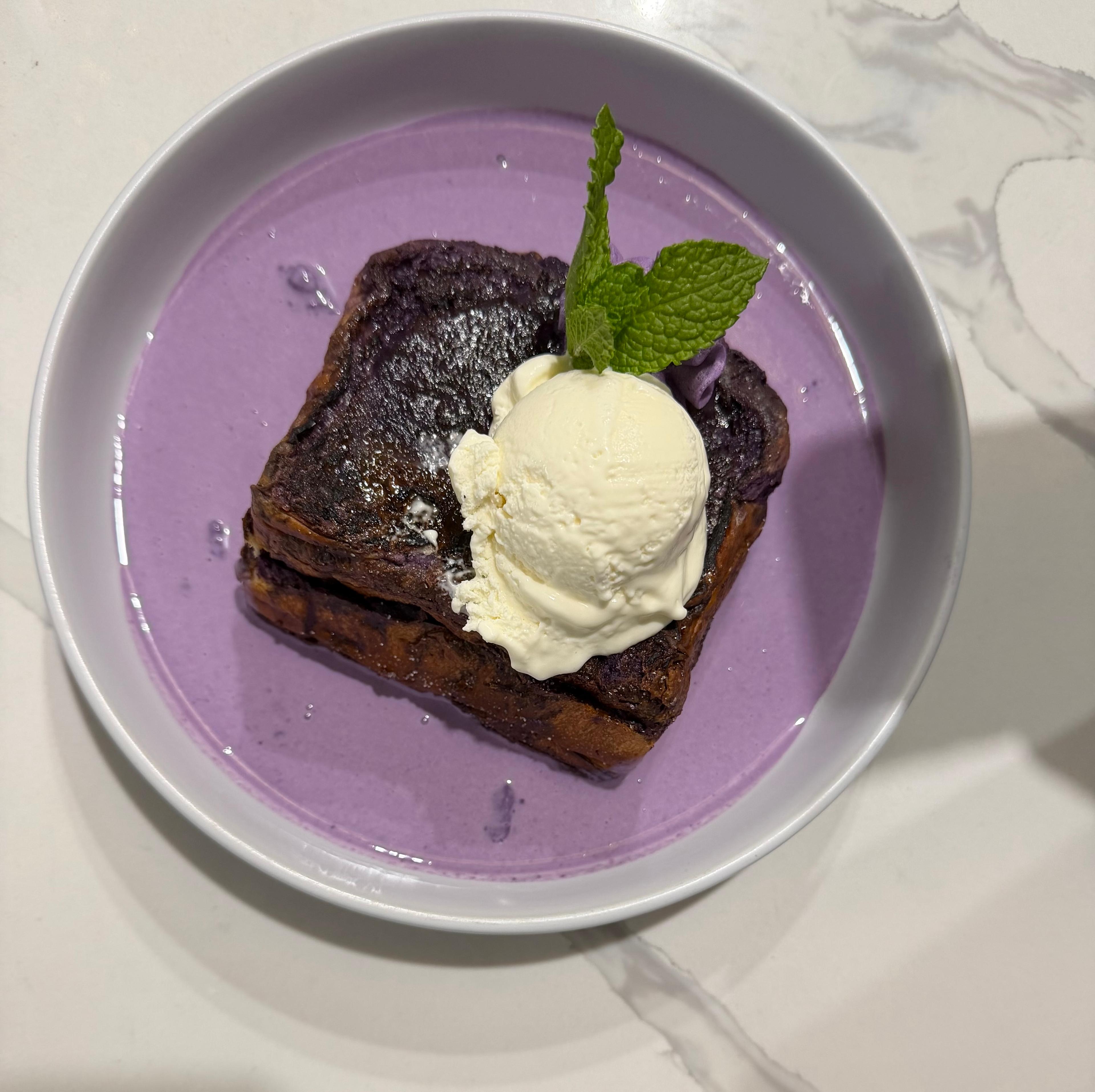 Purple yam French toast with vanilla ice cream scoop and mint leaf