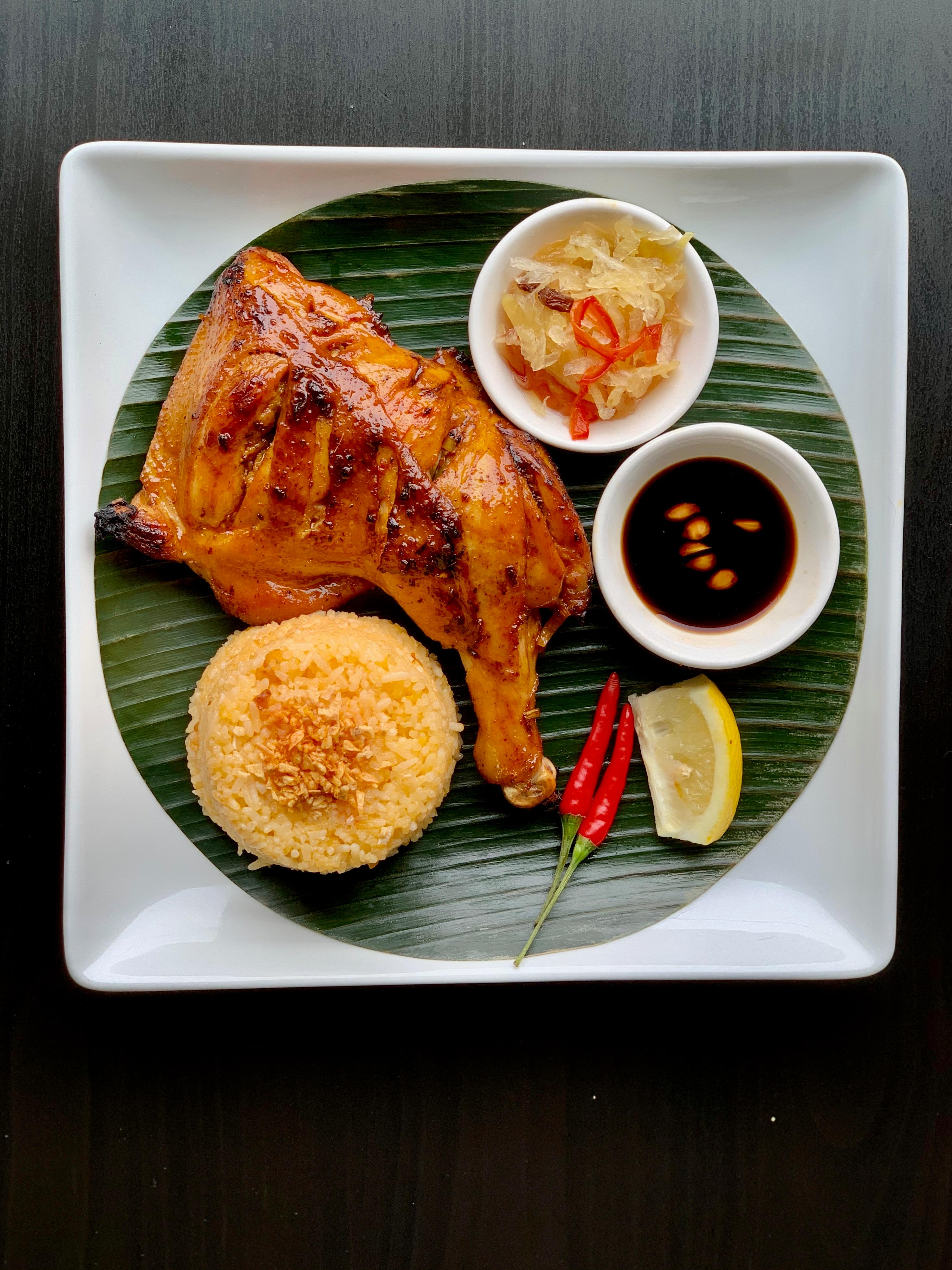 Grilled chicken leg with garlic rice, pickled vegetables, soy dipping sauce